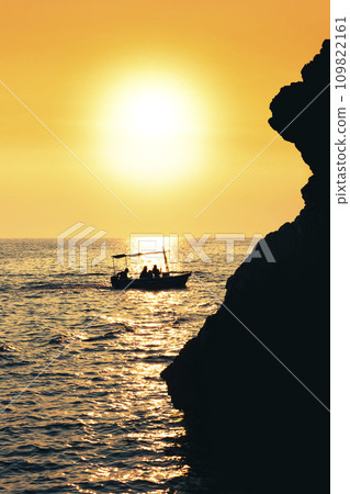 Boat sailing at sea at beautiful Sunset 109822161