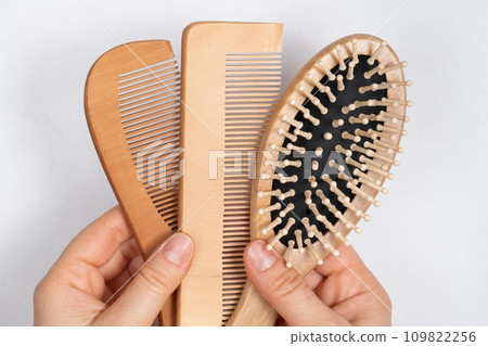 Wooden Combs In Woman's Hand, Natural Products In Hair Care 109822256