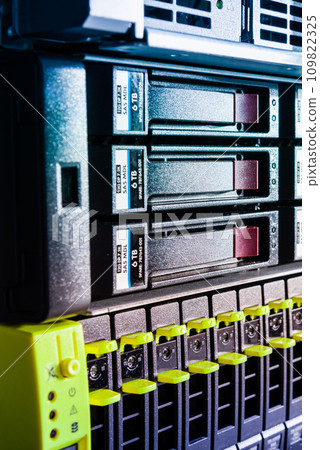Row of hard drives serving as data storage inside server room 109822325