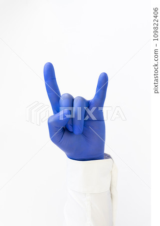 Hand in blue latex Glove giving Devil sign. Heavy metal Hand in blue latex Glove giving Devil sign. Heavy metal 109822406