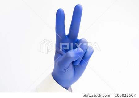Hand in blue latex Glove raising two fingers up on hand it is shows peace strength fight or victory symbol Hand in blue latex Glove raising two fingers up on hand it is shows peace strength fight or victory symbol 109822567