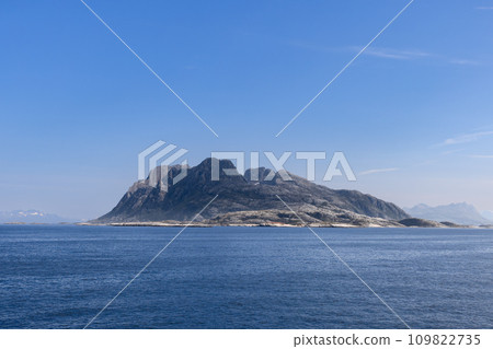 Serene summer tableau from ferry to Lofoten Island with a mountain rising above North Sea in Norway Serene summer tableau from ferry to Lofoten Island with a mountain rising above North Sea in Norway 109822735