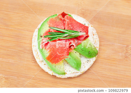 Rice Cake Sandwich with Fresh Avocado, Jamon and Rosemary 109822979
