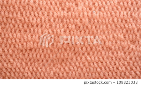 Peach fuzz color knitted texture. Peach fuzz color knitted texture. 109823038