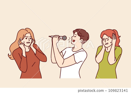 Man sings karaoke poorly due to lack of hearing or voice and forces women to cover ears Man sings karaoke poorly due to lack of hearing or voice and forces women to cover ears 109823141