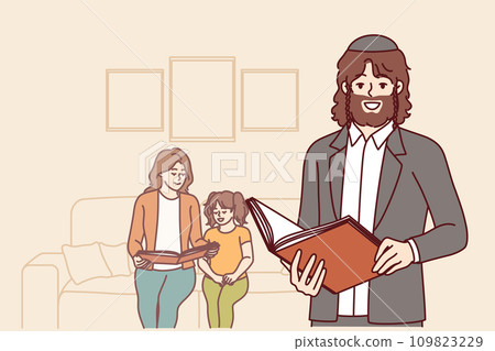 Orthodox jewish man with bible in hands stands near wife and daughter and holds book with prayers 109823229