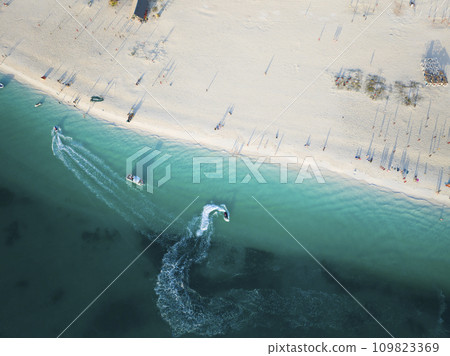 Birds view of boats in the green ocean and beautiful white sandy beach Birds view of boats in the green ocean and beautiful white sandy beach 109823369