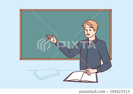 Priest teaching sunday school visitors stands near blackboard, tells students about benefits prayer 109823513