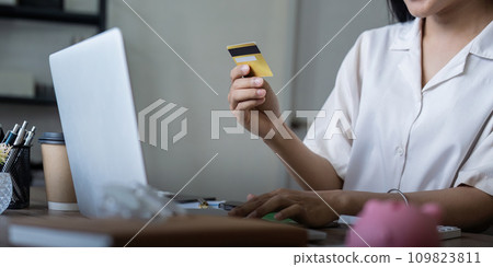 Woman on desk with laptop, credit card and ecommerce payment for online shopping at home. Happy female customer, digital bank app and sale on store website with internet banking 109823811