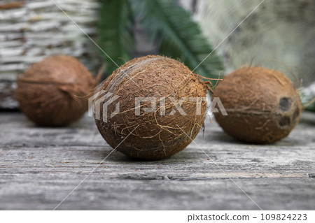 Coconuts on a old rustic wooden surface 109824223