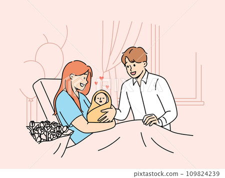 Mother with newborn baby sits on couch in hospital and shows infant to happy father 109824239