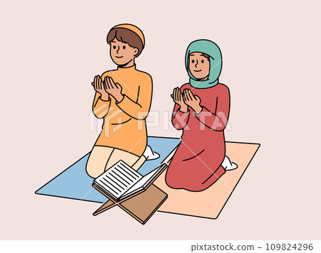 Little islamic children pray sitting on knees near holy quran studying in muslim school 109824296