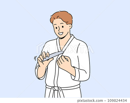 Man uses nail file after shower, performing daily hygiene and SPA procedures to take care of skin 109824434