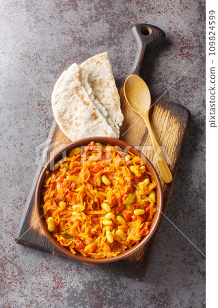 Chakalaka is a South African vegetable relish usually spicy, that is traditionally served with bread closeup on the table. Vertical top view Chakalaka is a South African vegetable relish usually spicy, that is traditionally served with bread closeup on the table. Vertical top view 109824599
