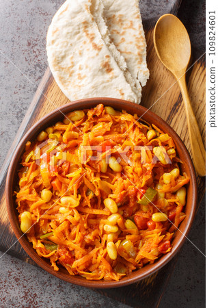 South African vegetable relish or side dish called Chakalaka closeup on the bowl. Vertical top view 109824601