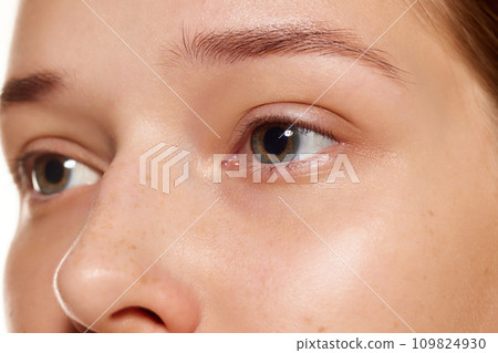 Close up shot of of with beautiful female eyes without makeup and with well-kept skin. Anti-aging treatment, rejuvenation. Close up shot of of with beautiful female eyes without makeup and with well-kept skin. Anti-aging treatment, rejuvenation. 109824930