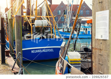 Traditional old german fishing cutter boats moored Neuharlingersiel harbor Wadden sea East Frisia Northern Germany. Commercial fish crab shrimp trawler beam trawl nets North Sea small port city Traditional old german fishing cutter boats moored Neuharlingersiel harbor Wadden sea East Frisia Northern Germany. Commercial fish crab shrimp trawler beam trawl nets North Sea small port city 109826587