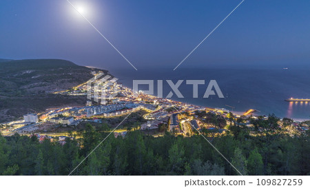 Aerial view of the coastline of the village of Sesimbra day to night timelapse. Portugal Aerial view of the coastline of the village of Sesimbra day to night timelapse. Portugal 109827259