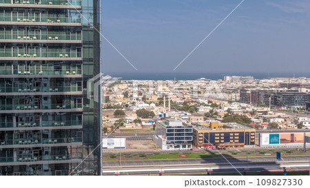 Aerial panoranic view to Dubai City Walk district behind skyscraper timelapse from above 109827330