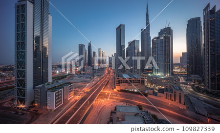 Aerial view of Dubai Downtown skyline with many towers night to day timelapse. 109827339