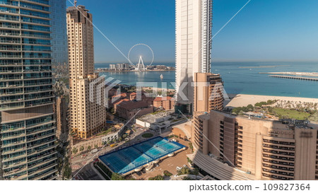 Panoramic view of the Dubai Marina and JBR area and the famous Ferris Wheel aerial timelapse 109827364
