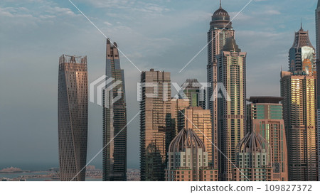 Skyscrapers of Dubai Marina near intersection on Sheikh Zayed Road with highest residential buildings night to day timelapse 109827372