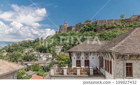Panorama showing Gjirokastra city from the viewpoint with the fortress of the Ottoman castle of Gjirokaster timelapse. 109827432