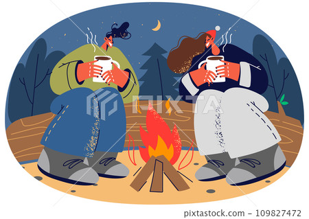 Happy couple relax near campfire in forest 109827472