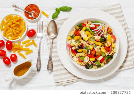 fusilli salad with mozzarella, veggies in a bowl 109827725