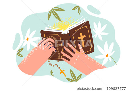 Bible with christian crucifix in hands of man studying catholic canons from books describing gospel 109827777