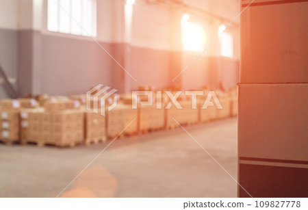 Tobacco and alcohol products in cardboard boxes in a warehouse against a sunset background. Detention of illegal cargo. Copy space for text 109827778