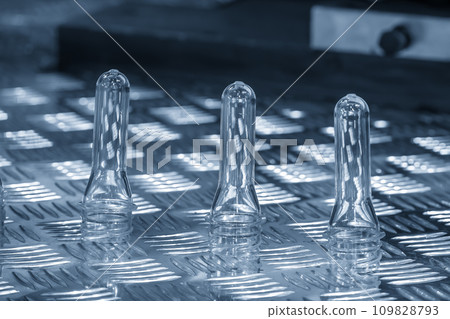 Close up scene of group of preform shape of PET bottle products. Close up scene of group of preform shape of PET bottle products. 109828793