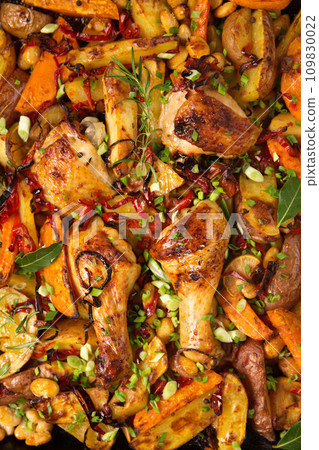 Baked vegetables with ruddy baked chicken, copy space 109830022