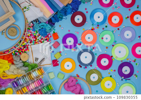 Flat lay DIY with hand embroidery with satin ribbons.  109830355