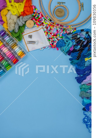 Flat lay DIY with hand embroidery with satin ribbons. Flat lay DIY with hand embroidery with satin ribbons. 109830356