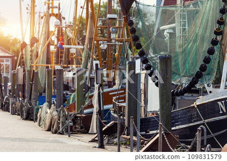 Traditional old german fishing cutter boats moored Neuharlingersiel harbor Wadden sea East Frisia Northern Germany. Commercial fish crab shrimp trawler beam trawl nets North Sea small port city Traditional old german fishing cutter boats moored Neuharlingersiel harbor Wadden sea East Frisia Northern Germany. Commercial fish crab shrimp trawler beam trawl nets North Sea small port city 109831579