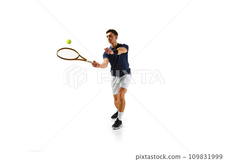 Competitive man in his 30s, tennis player in motion, hitting ball with racket, practicing isolated over white background Competitive man in his 30s, tennis player in motion, hitting ball with racket, practicing isolated over white background 109831999