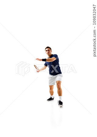 Full-length image of young man, tennis athlete in motion, playing, practicing isolated over white background 109832047