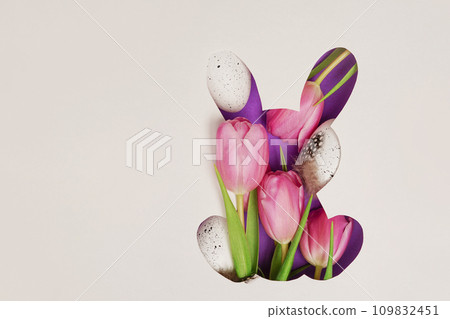Bunny shape Easter holiday composition with pink tulips and white eggs, paper background. Easter greeting card Bunny shape Easter holiday composition with pink tulips and white eggs, paper background. Easter greeting card 109832451