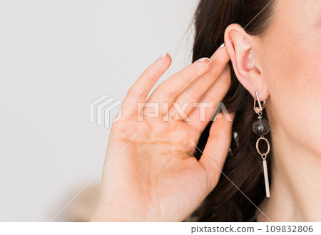 Detail of young woman wearing beautiful luxury earring. Handmade jewellery and accessories, copy space and empty place for text Detail of young woman wearing beautiful luxury earring. Handmade jewellery and accessories, copy space and empty place for text 109832806