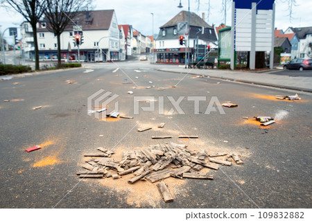 Fireworks rocket launcher box trash remains on german city street after Silvester party traditional celebration. Spoiled firecrackers waste rubbish european Germany town sidewalk Christmas New year 109832882