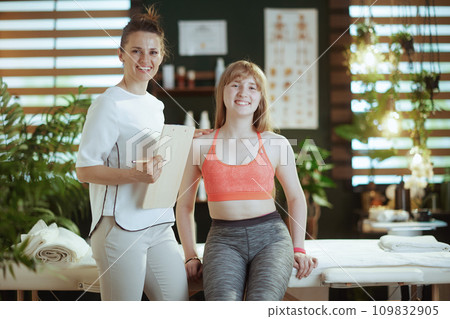 smiling female therapist in massage cabinet doing checkup 109832905