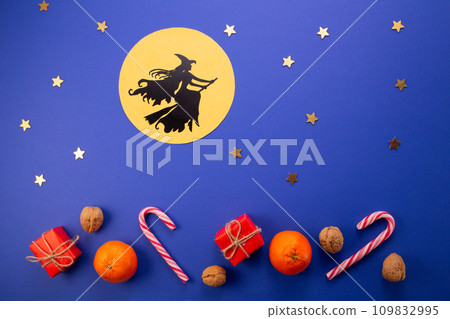 Epiphany day tradition.Witch Befana flying on broomstick on dark blue background. Candy, nuts, gifts Epiphany day tradition.Witch Befana flying on broomstick on dark blue background. Candy, nuts, gifts 109832995
