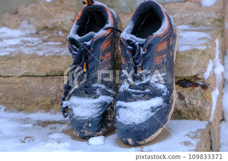 work shoes covered with fresh snow on the stairs work shoes covered with fresh snow on the stairs 109833371
