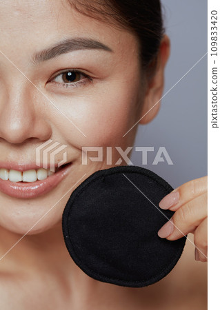 Closeup on modern woman with black cotton pad Closeup on modern woman with black cotton pad 109833420