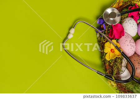 Medicine stethoscope with Easter eggs on spring green background. easter card with copy space Medicine stethoscope with Easter eggs on spring green background. easter card with copy space 109833637