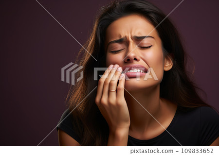 Dental Discomfort Woman Expressing Toothache, Clutching Cheek on a Radiant Purple Background. created with Generative AI 109833652
