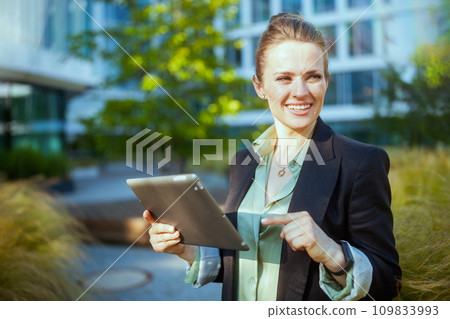 happy modern 40 years old woman worker near office building happy modern 40 years old woman worker near office building 109833993
