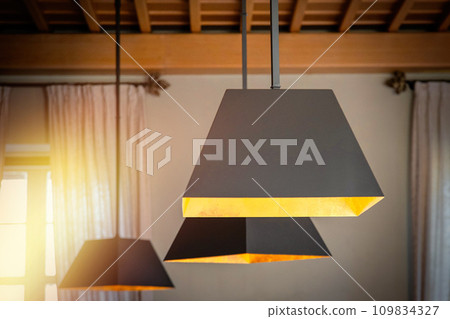 Modern hanging lamps in a classic cozy interior Modern hanging lamps in a classic cozy interior 109834327