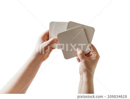 Hands, beer coasters 109834628